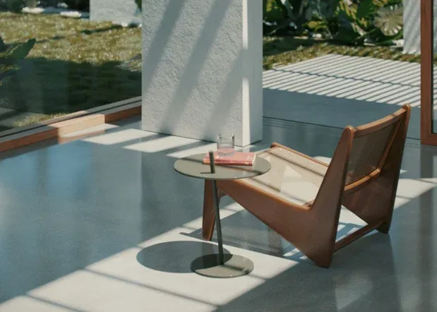 Covered concrete patio with seating beside large windows